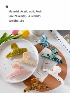 Detail view of 9.5cm marble acetate hair claw clip with specific size measurements
