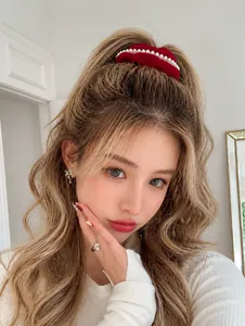 Close-up of velvet scrunchie with white imitation pearls on a ponytail hairstyle
