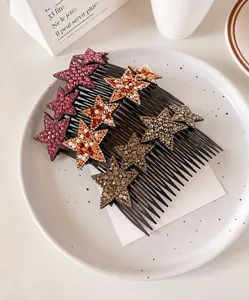 Detail of star-shaped hair combs with inlaid rhinestones in pink, orange, and gray