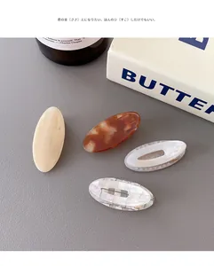 Set of four stylish hair clips with tortoiseshell and marble patterns on leather