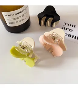 Three-color minimalist shark clips in black, cream pink, and avocado green tones