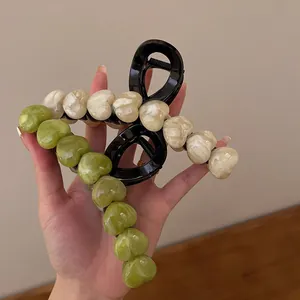 Elegant large heart hair claw clip with marble texture in green and cream finish