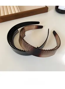 Detail of non-slip inner teeth on black and amber leopard print wide headbands