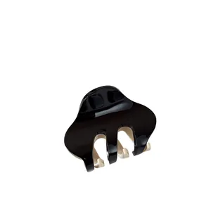 Minimalist small two-tone hair claw clip with black and white glossy finish and three teeth
