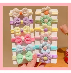 Detailed view of 12-piece elastic baby headbands with ribbon bows and floral designs