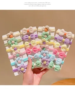 Close-up of colorful floral hair ties and bows on white display cards for girls
