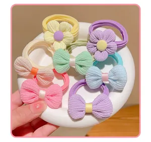 Detail of high-elastic kids hair ties with pastel fabric bows and floral textures