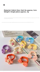 Detailed close-up of colorful flower and bow fabric hair ties for girls on a soft background