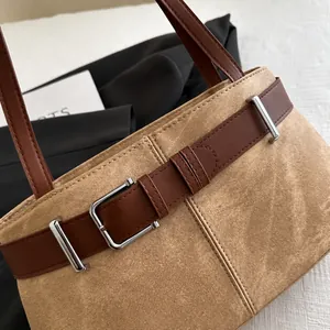 Detail showing high-quality canvas texture with brown leather belt buckle and silver metal hardware