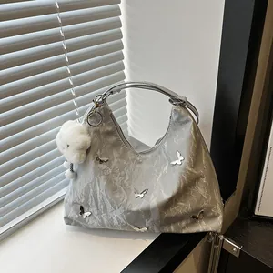 Silver metallic crossbody bag with 3D butterfly charms and cloud pendant accessory