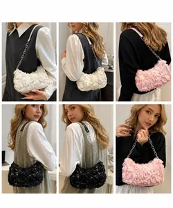 Detail view of 3D rose fabric clutch with elegant chain strap in white, pink, and black