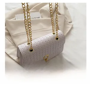 Detail of light purple woven PU leather bag featuring a gold chain strap and metal eyelet design