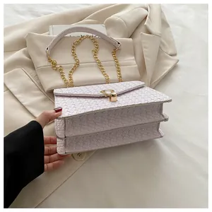 Detail of light purple PU leather crossbody bag with woven texture and gold chain strap