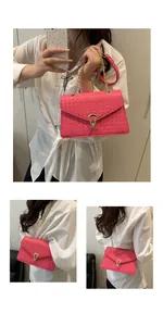 Detail of woven fuchsia PU leather bag with gold chain strap and metal clasp