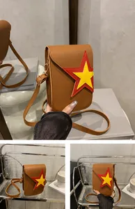 Detailed view of the brown crossbody bag with star logo and golden metal hook