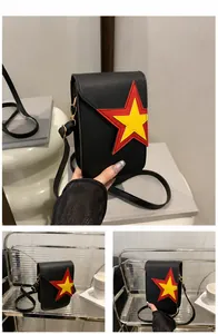 Detail of black crossbody phone bag with double-layered star design and glossy finish