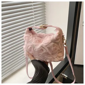 Detail of pink floral handbag with 3D mesh roses and gold metal hardware clips