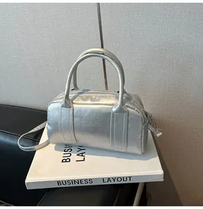 Detailed close-up of the silver Boston bag with sleek metallic finish and logo