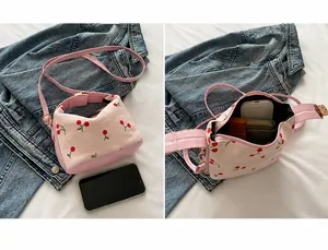 Internal view of pink corduroy cherry bag showing space for phone and lipstick