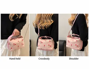 Pink cherry print bag detail showing handheld, crossbody, and shoulder carrying styles