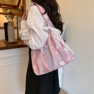Pink tote bag with daisy floral embroidery and lace ribbon bow for casual wear