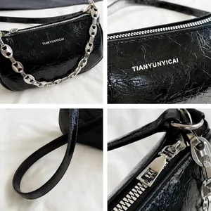 Detailed views of a black wrinkled patent leather shoulder bag with silver chain strap
