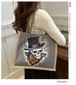 Close-up of stylish grey canvas tote bag with cartoon skull print on model shoulder