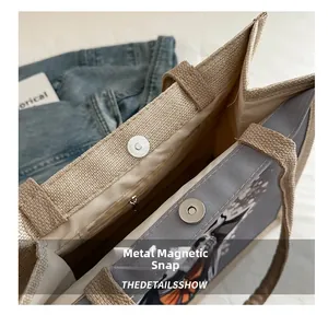 Detail of hardware magnetic closure and durable inner lining on a cartoon tote bag