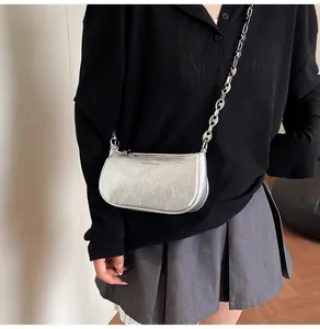 Silver metallic crinkled leather underarm bag with thick metal chain strap and brand logo