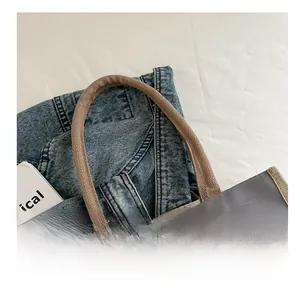 Close-up of durable woven handles and cartoon print on a grey canvas lunch tote bag