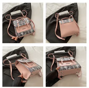 Detail view of a pink tweed mini backpack with fashion metal plaque and rivet accents