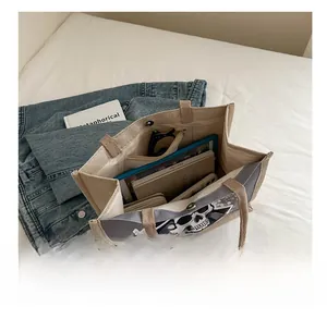 Internal view of a canvas tote bag showing its large capacity and inner zip pocket