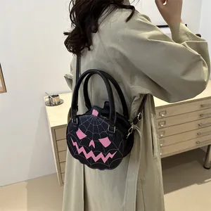 Halloween pumpkin-shaped shoulder bag in black and pink with spooky spider web patterns