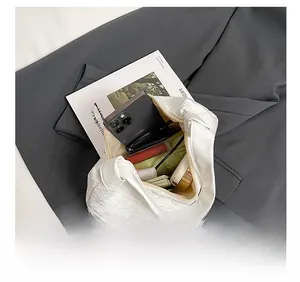 Top view of white woven tote bag interior showing large capacity for daily items