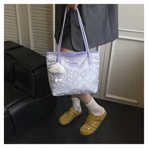 Detailed close-up of geometric jacquard tote bag with cute cloud charm in home setting