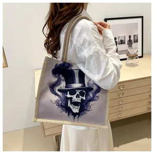 Detail of canvas tote bag with skull graffiti pattern and thick braided handles