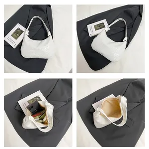 Detailed views of white woven tote showing half-moon shape and interior capacity