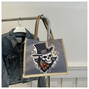 Detail of grey tote bag with gentleman skull print and linen trim on clothes hanger