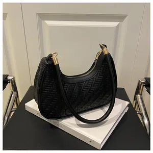 Detailed view of black woven hobo bag with gold zipper and stylish metal buckle on shoulder strap