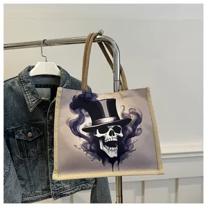 Detail of canvas tote bag featuring a skull with top hat and purple smoke design