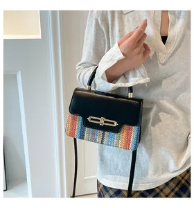 Detail showing colorful woven texture and gold twist lock on women's crossbody bag