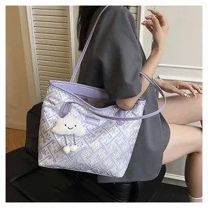 Close-up of purple geometric pattern tote bag with creative tag and cloud charm