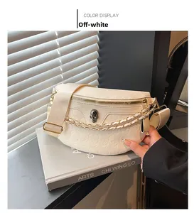 Detailed off-white chest bag featuring skull embossing and golden chain strap detail