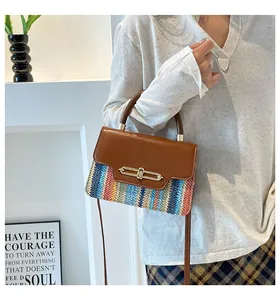 Detail of colorful woven crossbody bag with brown faux leather flap and gold lock