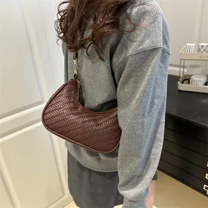 Minimalist dark brown woven leather hobo shoulder bag with elegant gold zipper