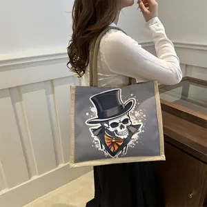 Chic grey canvas tote bag with a vintage skeleton illustration and beige woven straps