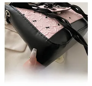 Detailed macro view of the precise stitching and pink fabric texture on a bow bag