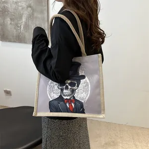 Fashionable beige canvas tote bag featuring a gentleman skull print and rope handles