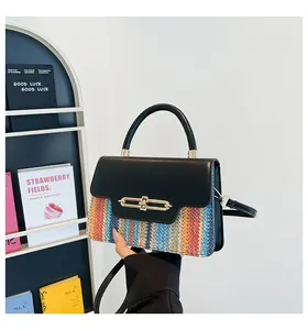 Detail of color-block crossbody bag with vertical woven pattern and gold metal buckle