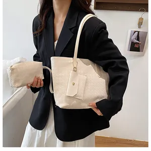 Three-piece beige textured leather tote bag set including handbag and small pouch